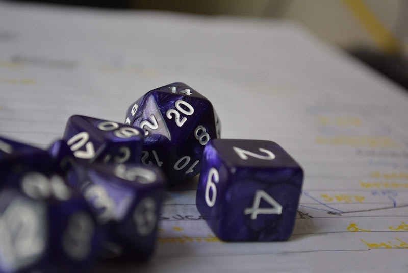 purple dice on a sheet of notebook paper