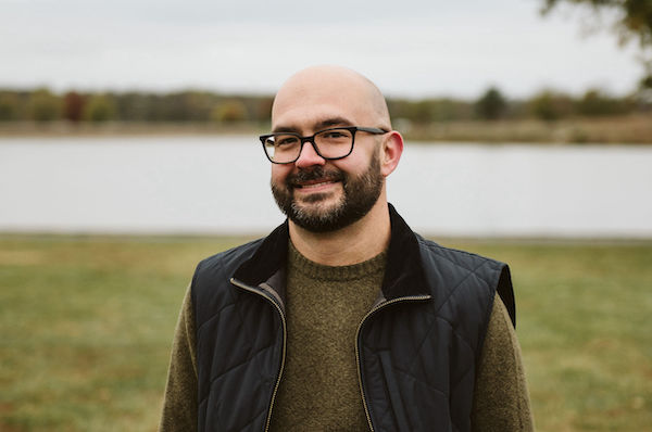 Doug Messel standing in front of a lake.